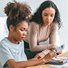 FinAid Thumb - Mother and daughter reviewing financial documents and using a calculator for college expenses