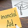 Sticky note with 'Financial Aid' written on it, next to a sketch of a graduation cap.